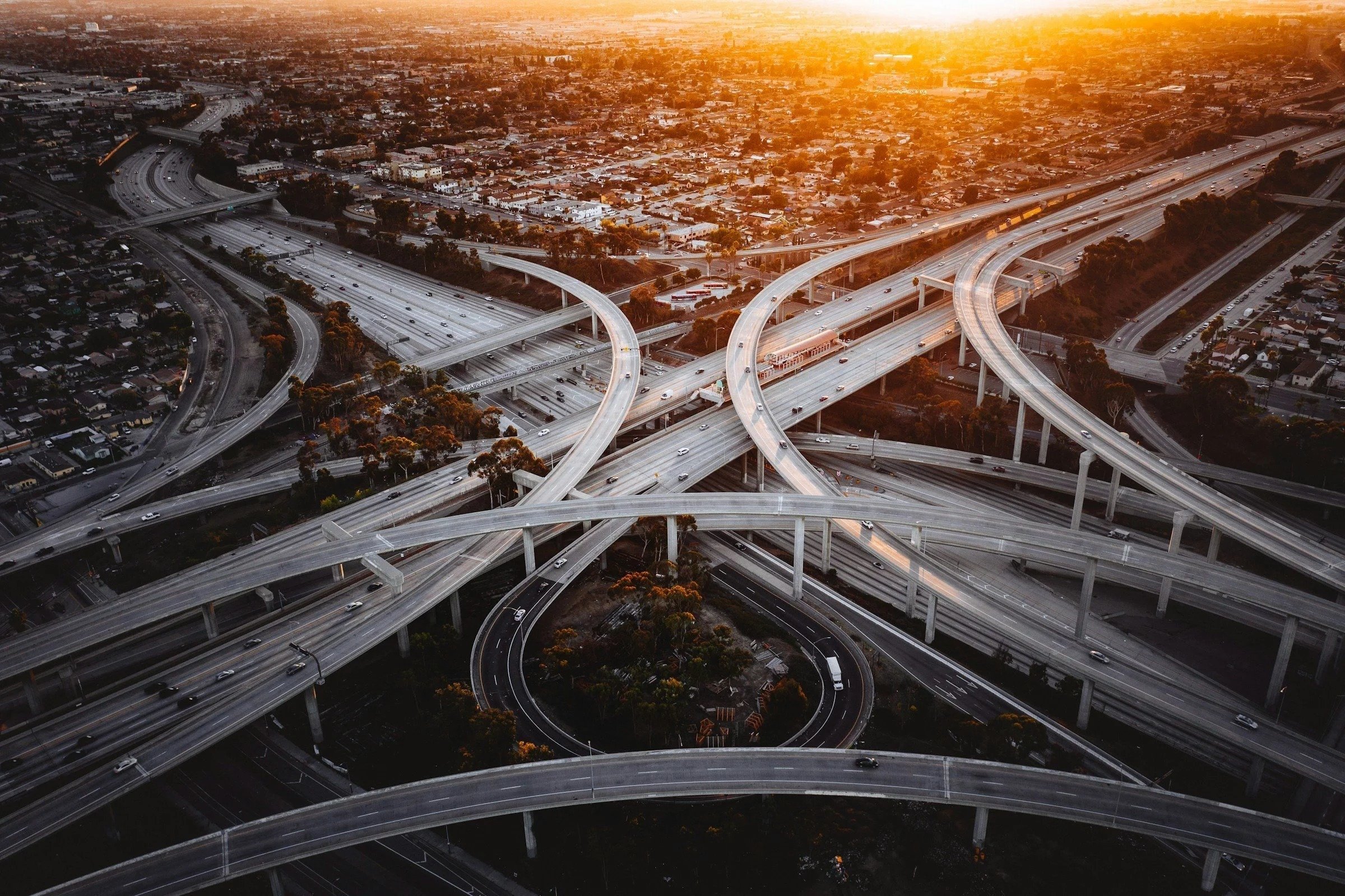 Aerial view of highways crisscrossing with sunset in the background