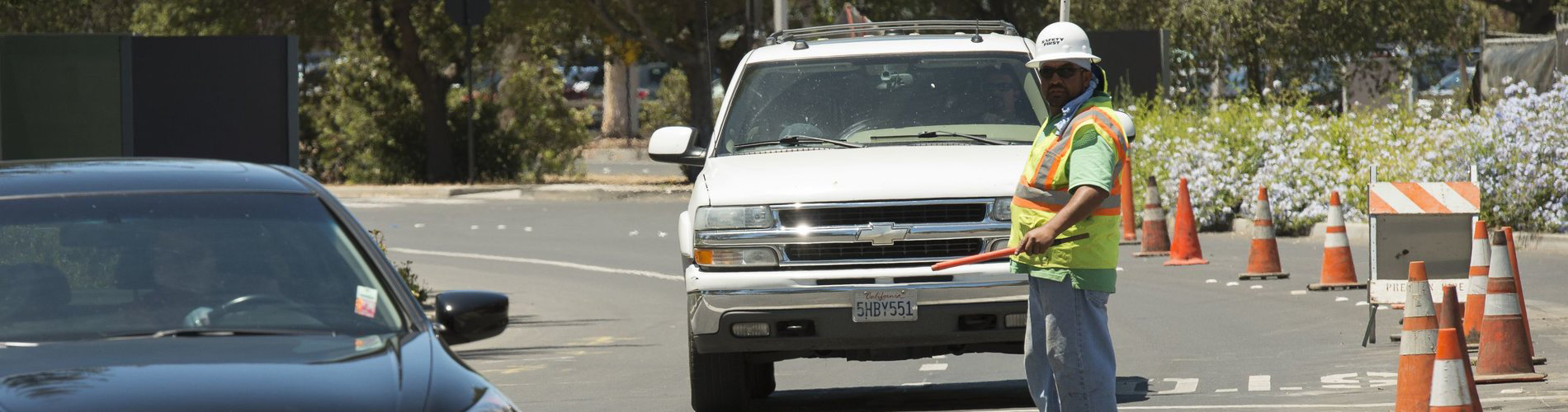 Person directing traffic around cones